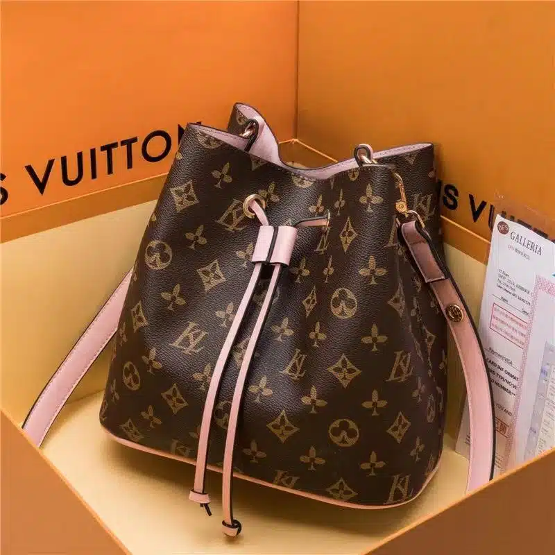 Louis Vuitton bucket bag dupe made with a brown monogrammed patten and pink accent.