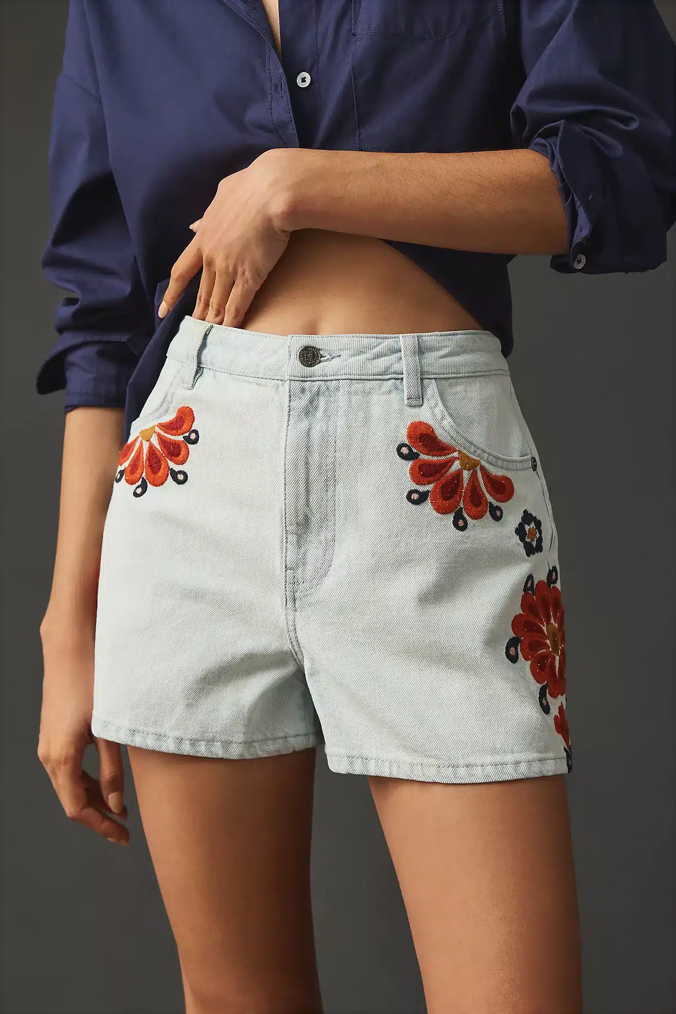 Farm Rio denim shorts in light blue with orange floral embroidery.