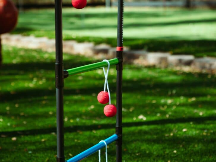 Ladder toss frame with balls over the rungs.
