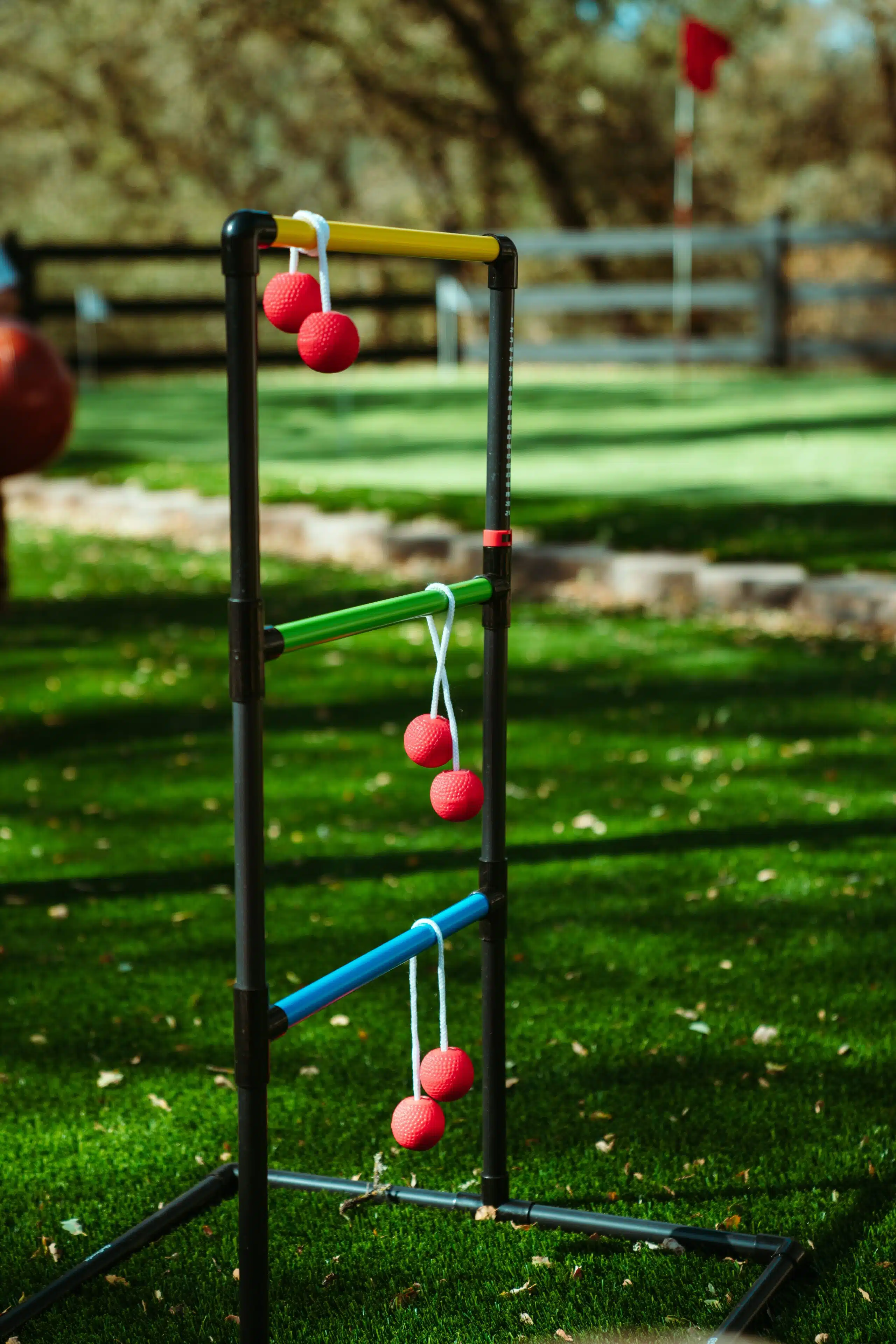 Ladder toss frame with balls over the rungs.