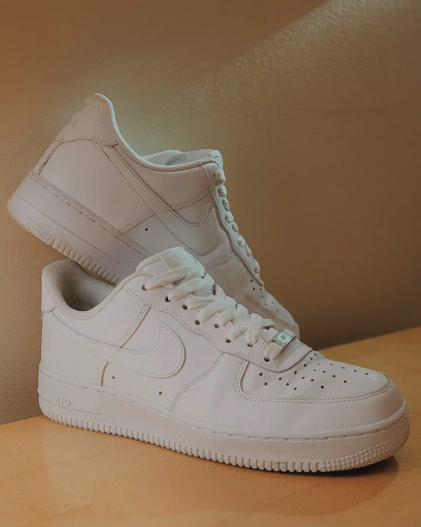 A pair of Nike Air Force 1 '07 women's white leather sneakers.