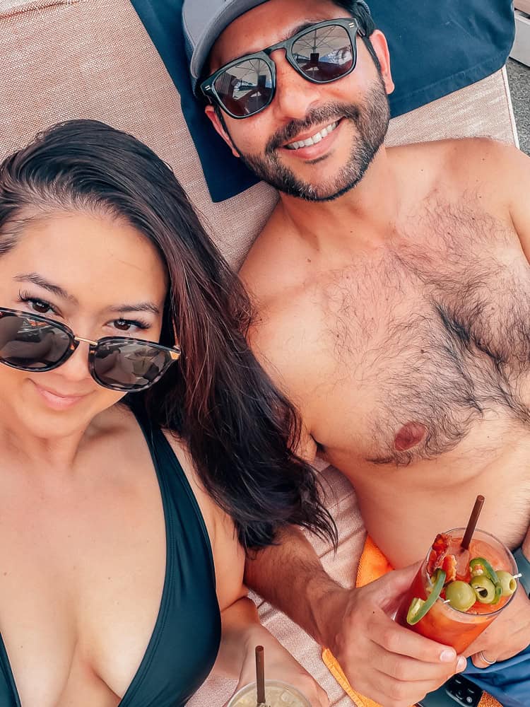 Elise and her husband poolside with drinks during a 24-hour staycation at Dr. Wilkinson's Calistoga
