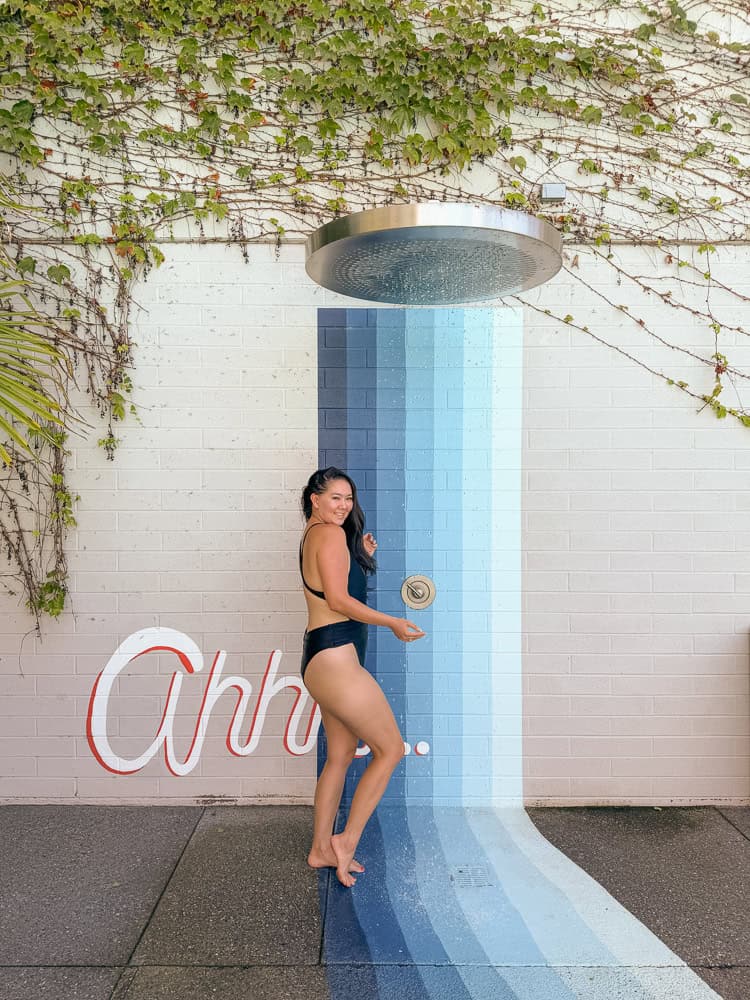 Outdoor shower with the Ahh neon sign by the mineral pools at Dr. Wilkinson's Calistoga